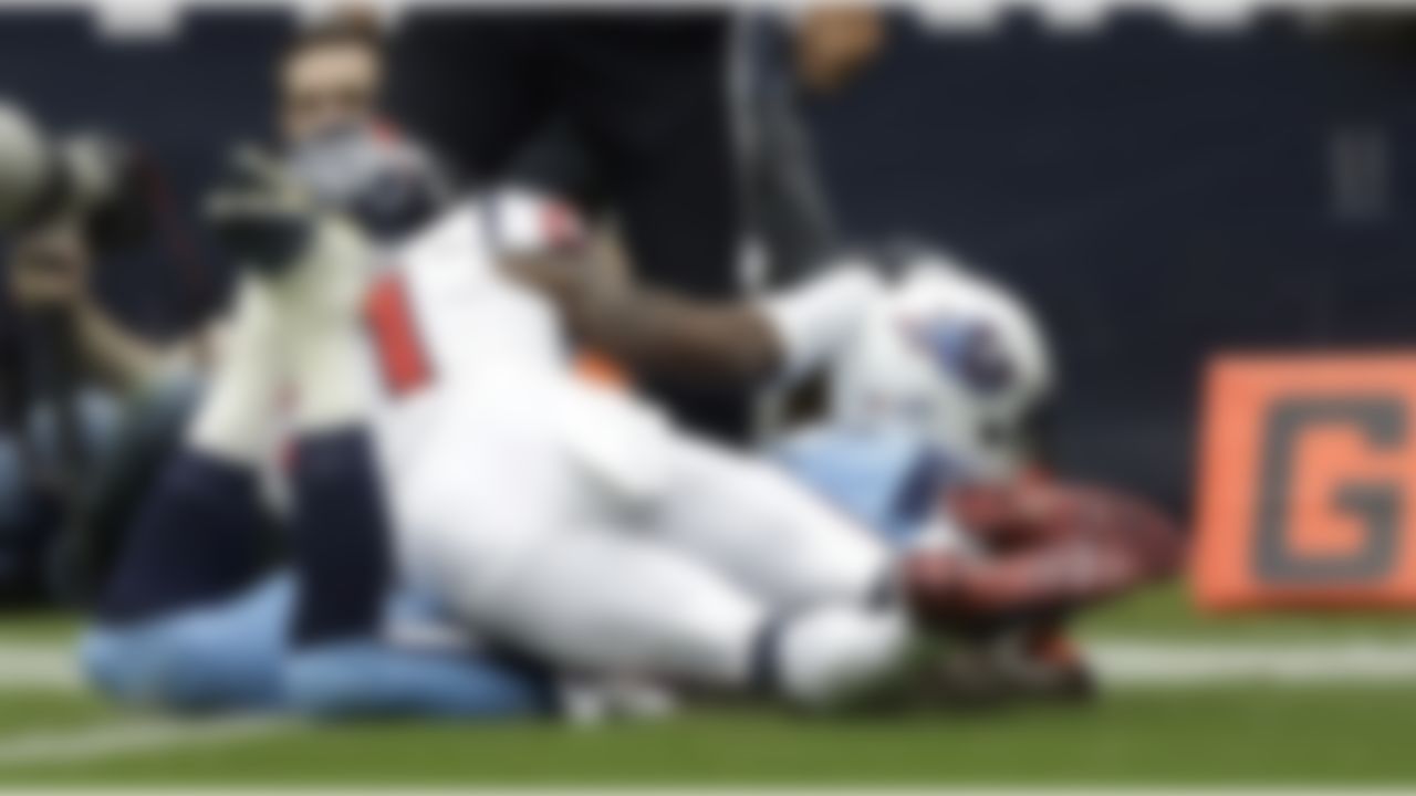 Tennessee Titans' Kendall Wright, right, scores a touchdown as Houston Texans' Brice McCain, left, defends during the first quarter of an NFL football game Sunday, Sept. 15, 2013, in Houston. (AP Photo/Patric Schneider)