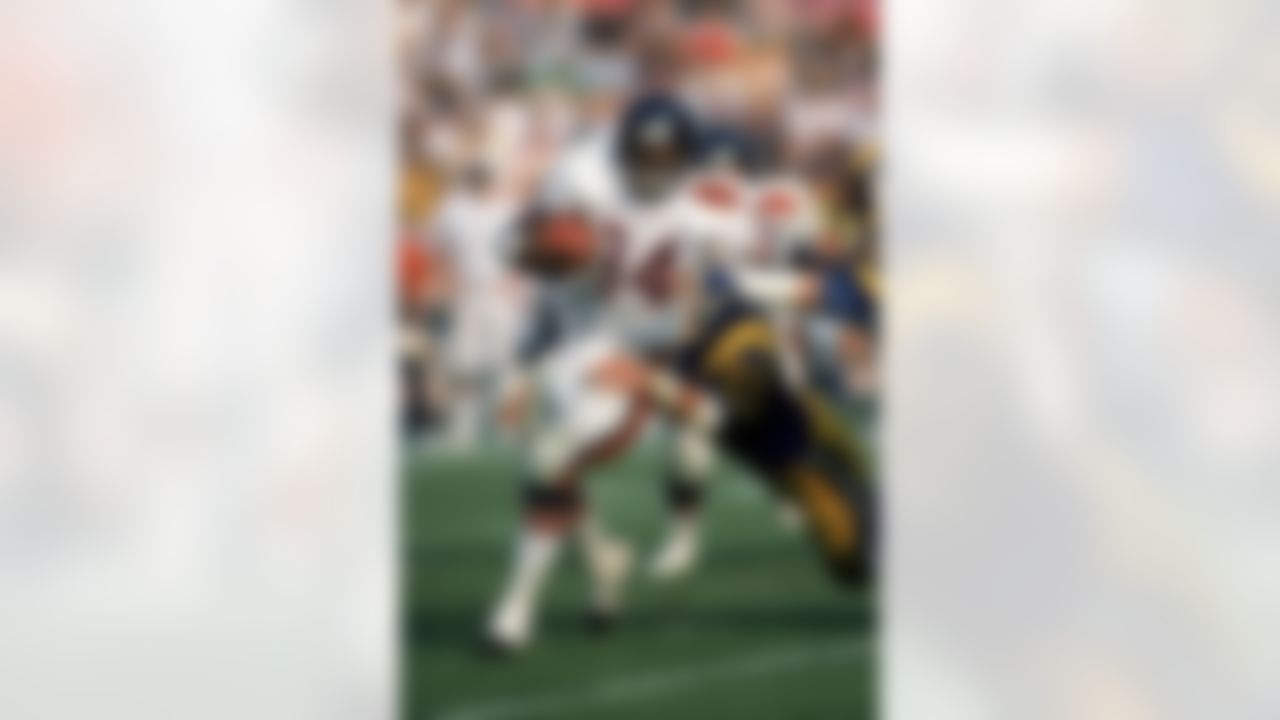 Running back Walter Payton #34 of the Chicago Bears tries to break away from a tackle by Los Angeles Rams linebacker Jim Collins #50 during a game at Anaheim Stadium on November 6, 1983 in Anaheim, California. (George Rose/Getty Images)