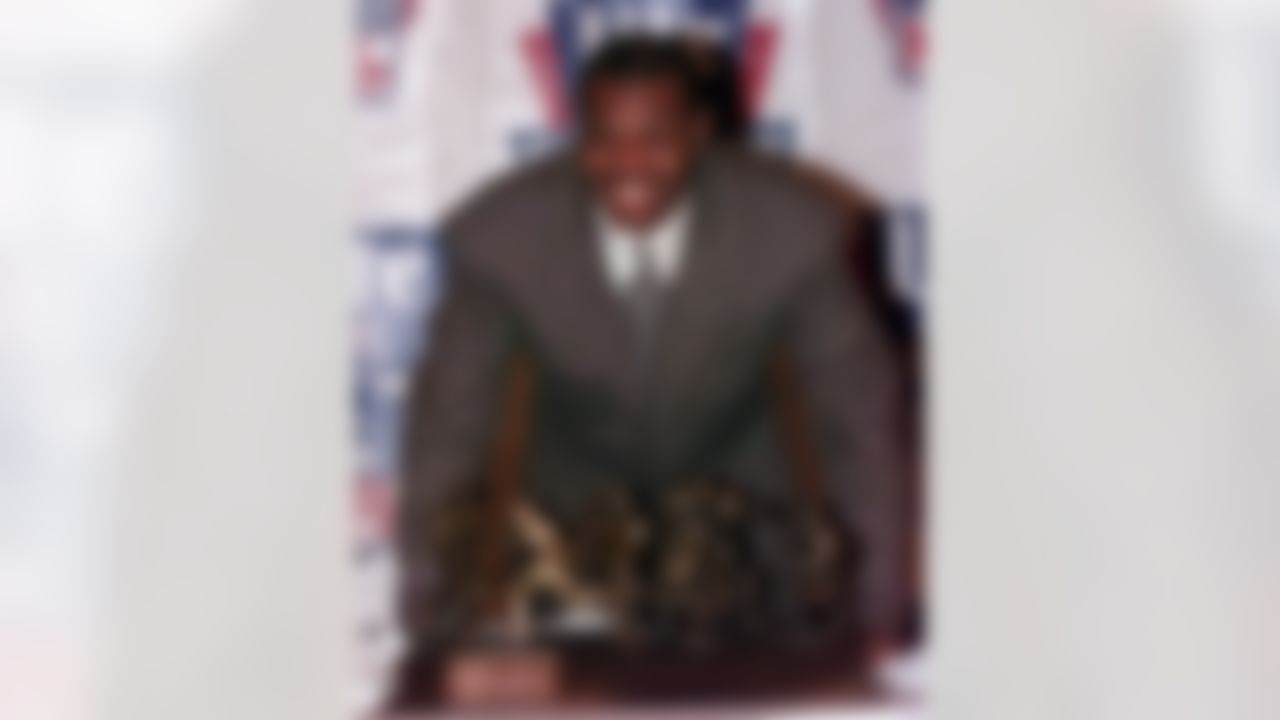 Minnesota Vikings quarterback Randall Cunningham is all smiles as he poses with the Miller Lite NFL Player of the Year trophy following the presentation in Miami on Wednesday, Jan. 27, 1999. (AP Photo/Dave Martin)