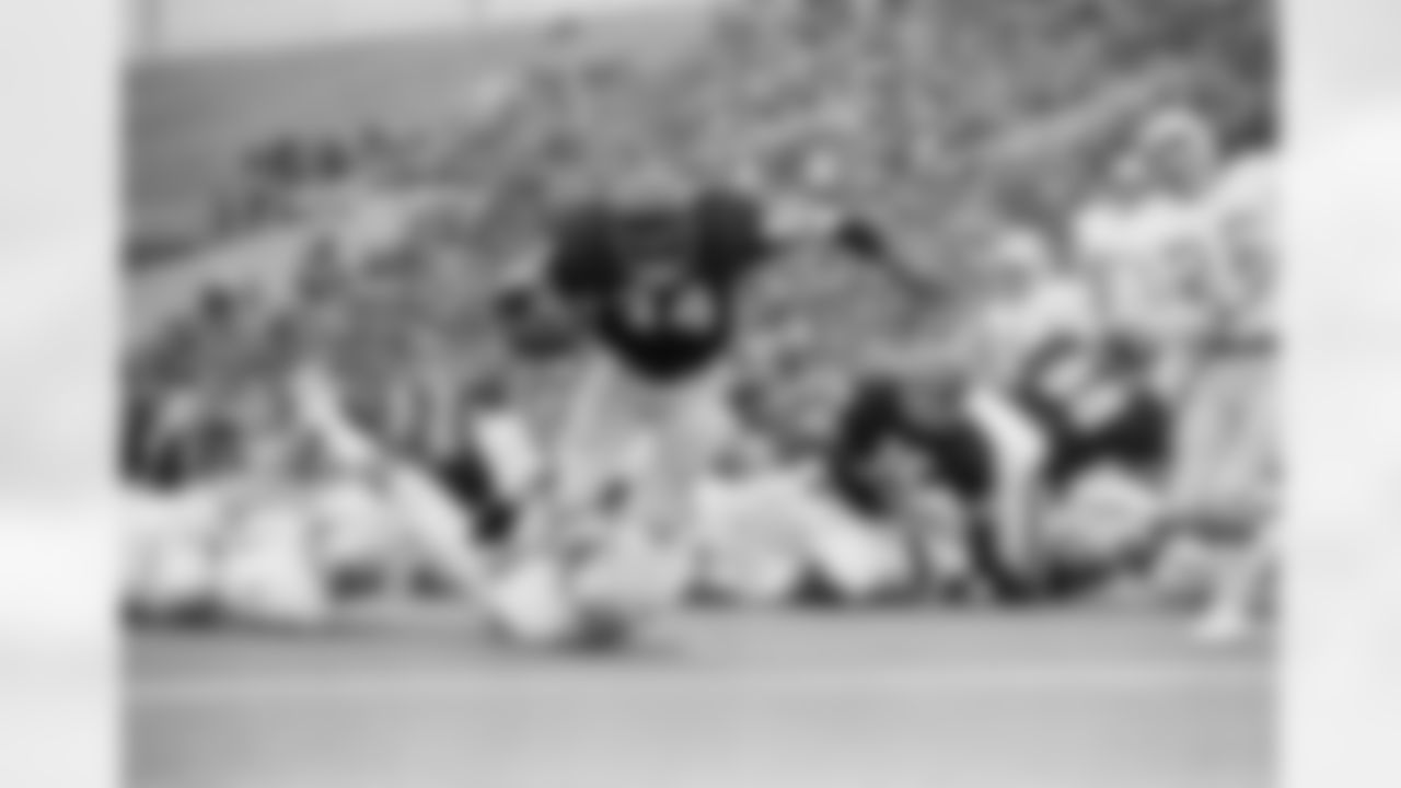 Chicago Bears running back Walter Payton (34) scrambles over Detroit Lions back Lem Barney to score in third period Sunday, Dec. 8, 1975 in Chicago. (Associated Press)