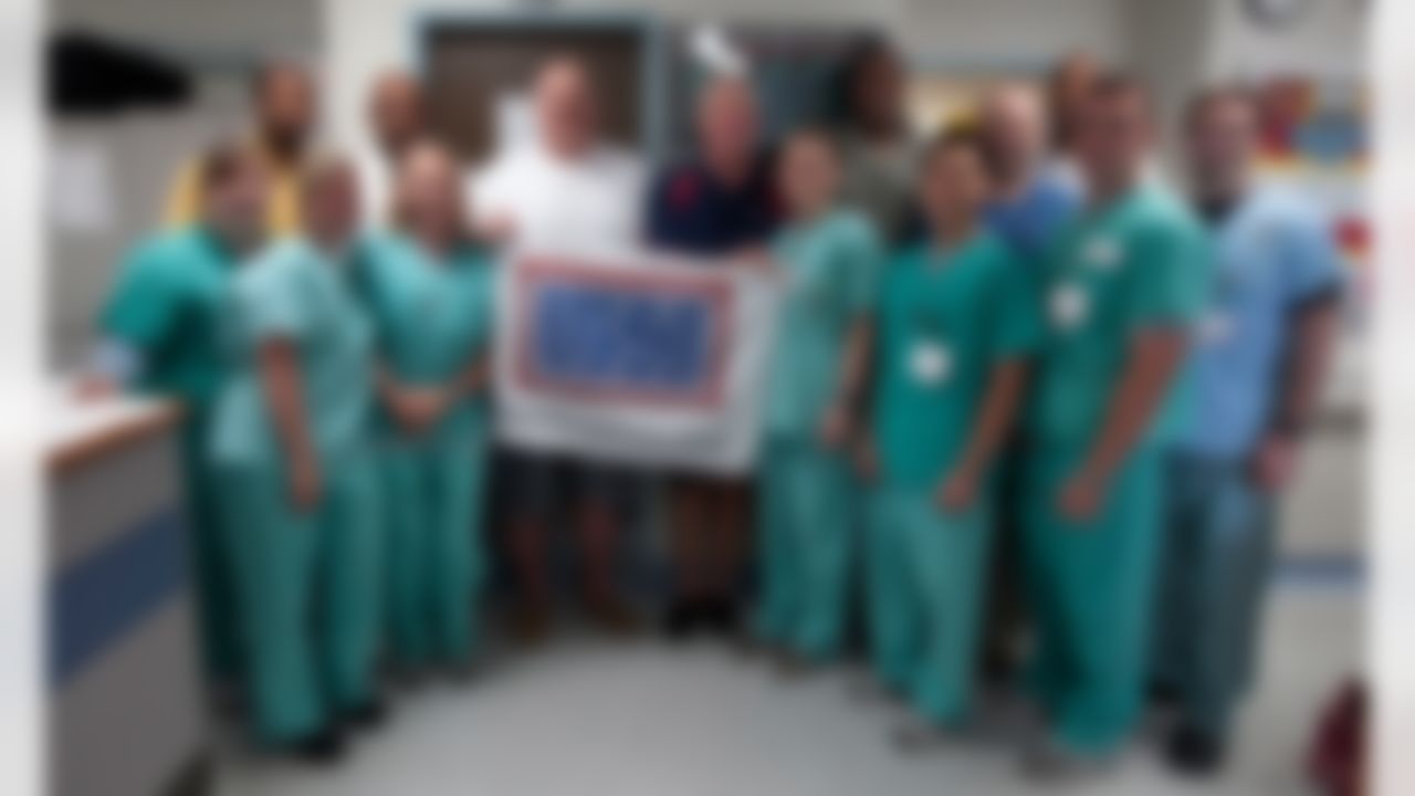 Marvin Lewis, Cincinnati Bengals head coach (second row 2nd l) Andy Reid, Philadelphia Eagles head coach (second row 3rd l), John Fox, Carolina Panthers head coach (second row 4th l) and Brad Childress, Minnesota Vikings head coach (second row 2nd r) pose with medical service members during a tour stop at Landsthul Regional Medical Center in Germany on June 29, 2010. For the second consecutive year, the National Football League (NFL) deployed four of its most sought-after coaches to the Persian Gulf to visit troops as part of a week-long USO/Armed Forces Entertainment tour. (Fred Greaves/USO)