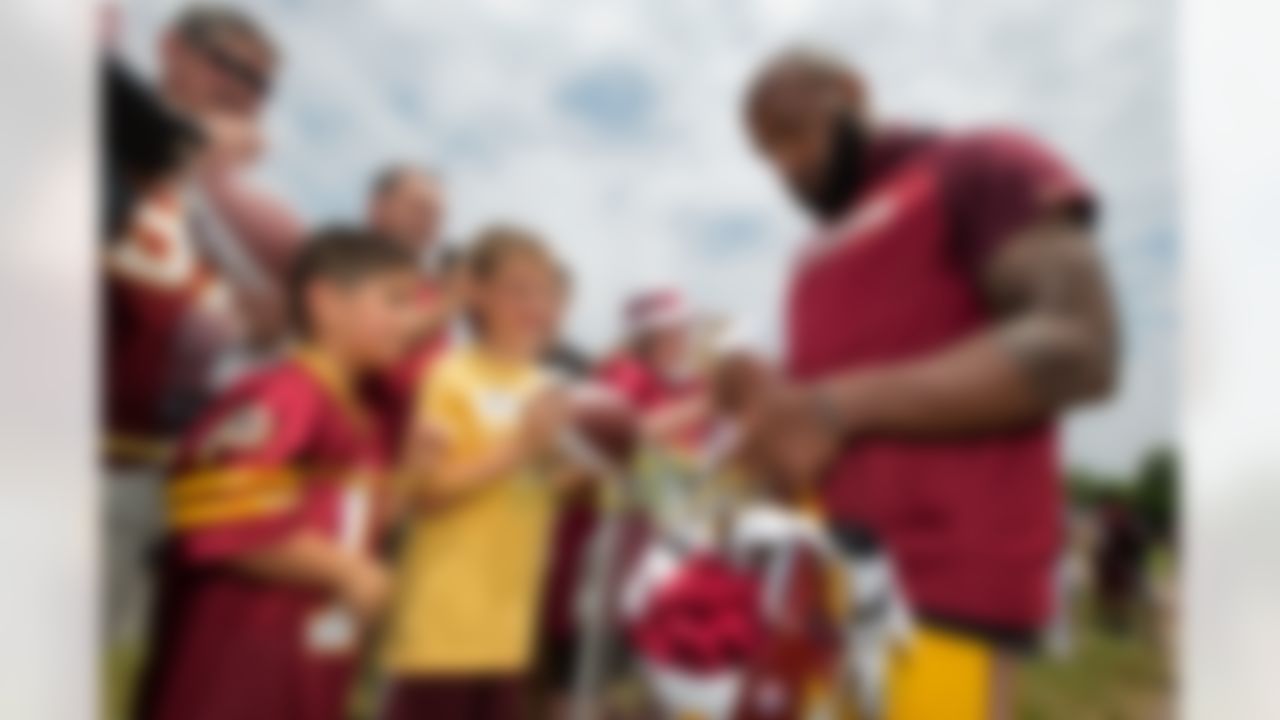 Washington Redskins safety DeAngelo Hall, right, signs autographs during the NFL football team's minicamp at the Redskins Park in Ashburn, Va., Wednesday, June 15, 2016.