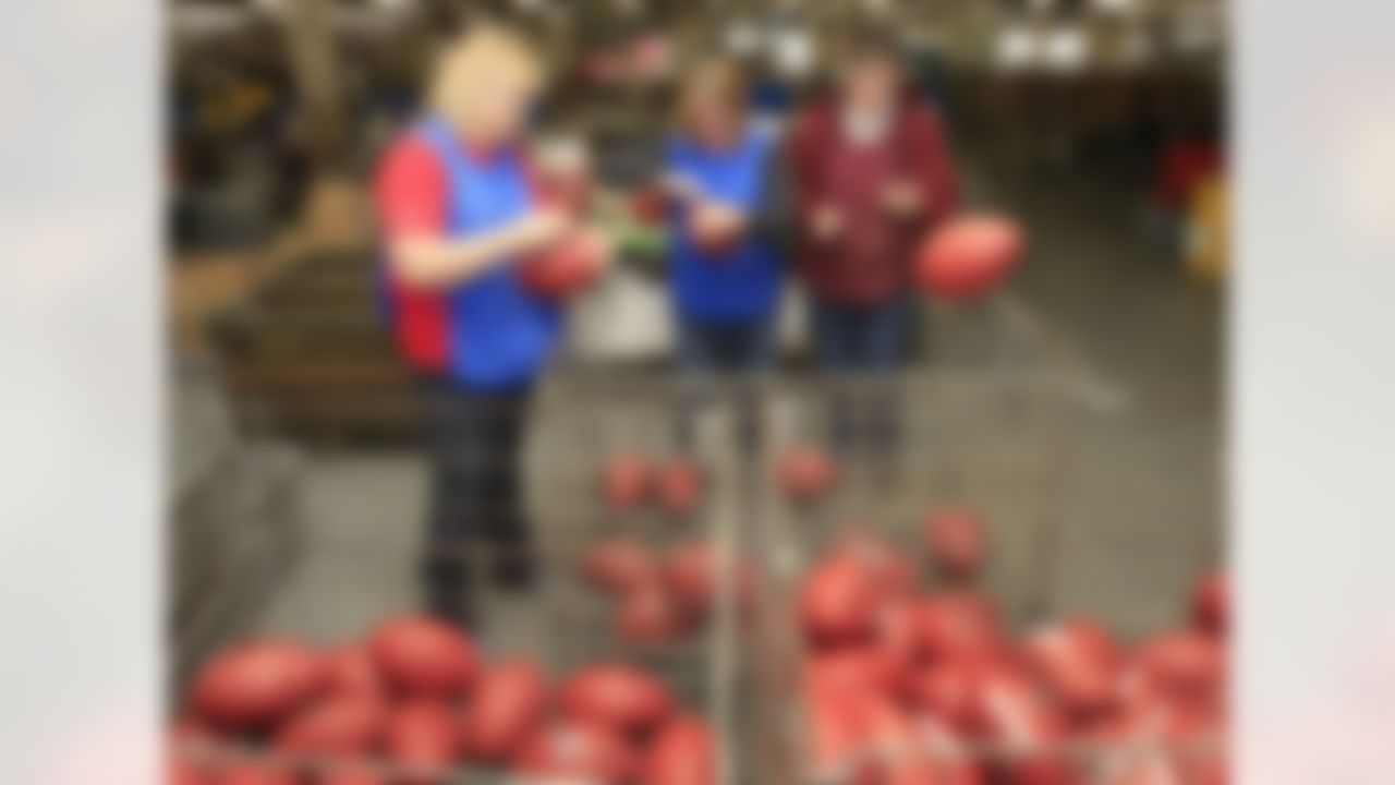 From left, June Hamilton, Pam Clark, and Barb Harnishfeger inspect the official game balls for the NFL football Super Bowl XLVI at Wilson Sporting Goods Co. in Ada, Ohio, Monday, Jan. 23, 2012. The New England Patriots will play the New York Giants in the Super Bowl on Feb. 5 in Indianapolis. (AP Photo/Tony Dejak)
