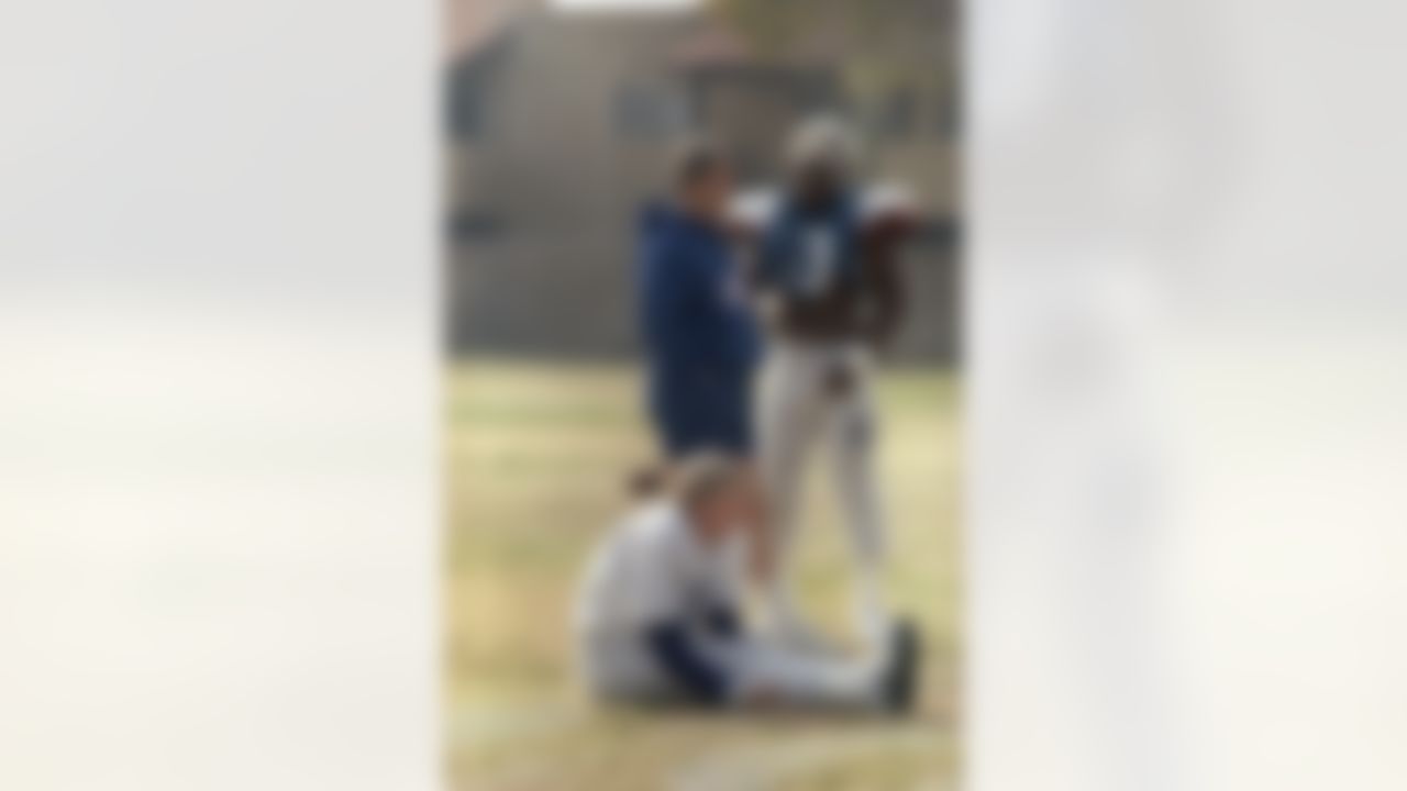 New York Giants linebacker Harry Carson (53) fastens his sweats and talks with head coach Bill Parcells as quarterback Phil Simms (11) limbers up at the start of workout in Anaheim, Jan. 23, 1987. (AP Photo/Ray Stubblebine)