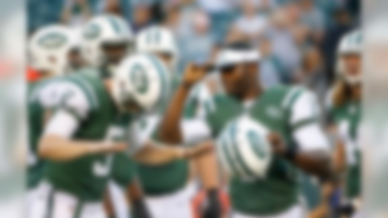 In this Aug. 28, 2014, file photo, New York Jets' Matt Simms (5) reacts as quarterback Michael Vick (1) leaves the game during the first half of an NFL preseason football game against the Philadelphia Eagles in Philadelphia. In the 13 years since his arrival as the fastest man on the field who also happened to have the best arm, Vick's impact has been felt in the way quarterbacks and offenses evolve in high school, college, and eventually, the pros. (AP Photo/Chris Szagola, File)