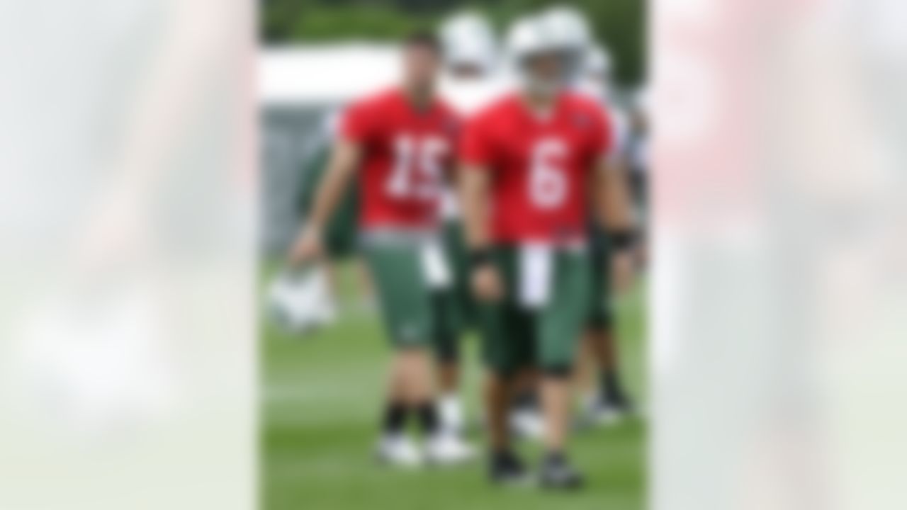 New York Jets quarterbacks Mark Sanchez (6) and Tim Tebow (15) look on during practice on opening day of their NFL football training camp Friday, July 27, 2012, in Cortland, N.Y. (AP Photo/Bill Kostroun)