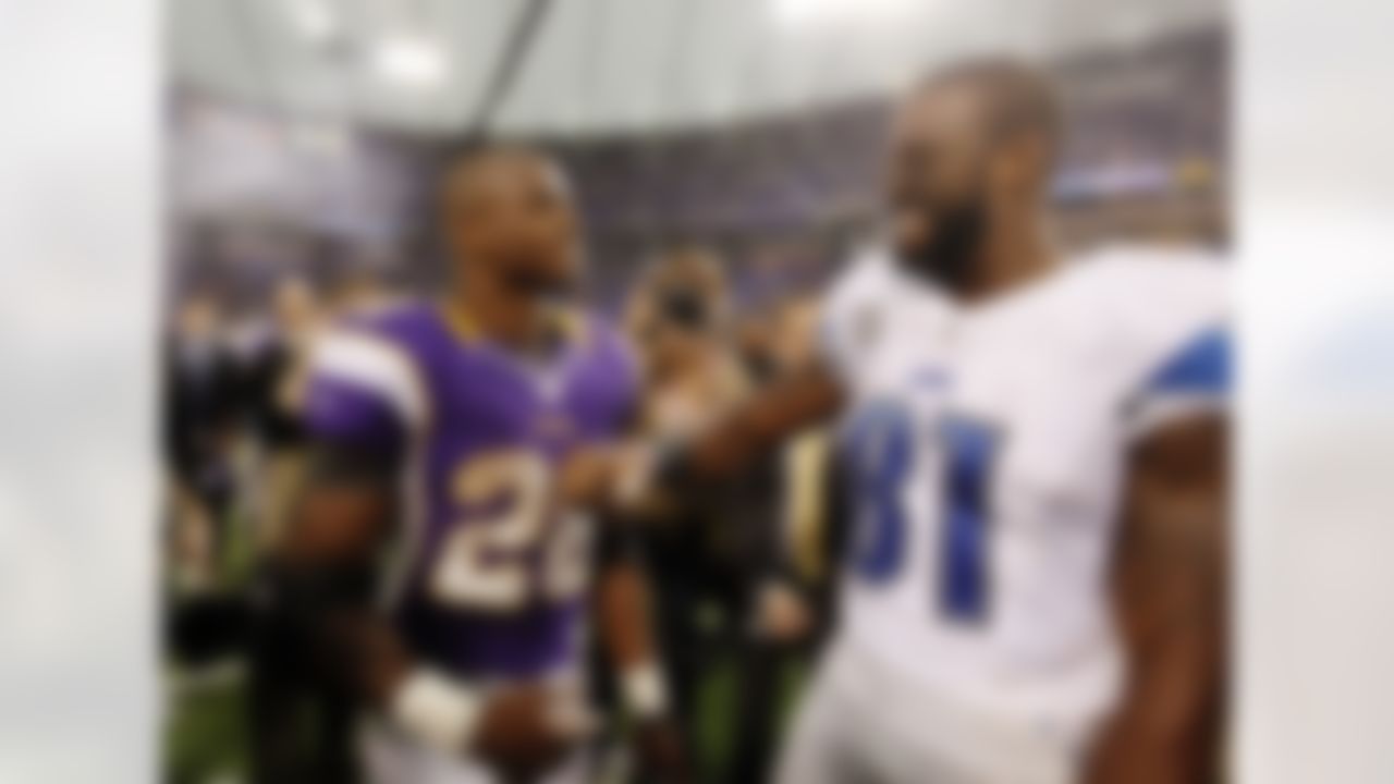 Detroit Lions wide receiver Calvin Johnson (81) and Minnesota Vikings running back Adrian Peterson (28) share a laugh after their NFL football game Sunday, Nov. 11, 2012, in Minneapolis. The Vikings won 34-24. (AP Photo/Genevieve Ross)