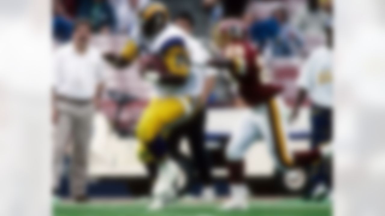 ANAHEIM, CA - NOVEMBER 21: Tight end Pat Carter #88 of the Los Angeles Rams eludes cornerbacks Tom Carter #25 and Darrell Green #28 of the Washington Redskins at Anaheim Stadium in Anaheim, California on Novemtber 21, 1993. The Rams defeated the Redskins 10-6. (Photo by Joseph Patronite/NFL Photos)