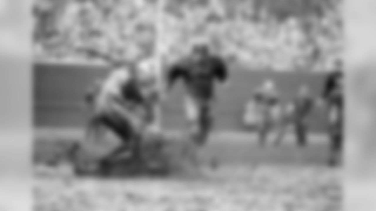 New York Giant Andy Nelson, almost obscured by sheet of flying mud and water, gets a face full of it as he hits the wet deck after knocking pass out of the hands of St. Louis Cardinals Jackie Smith (81) Nov. 15, 1964. But Nelson had even worse luck. He was called for pass interference and the Cardinals gained 23 yards on the play. Moving in on the action is Lou Slaby. Game was 10-10 tie. (AP Photo/Fred Waters)