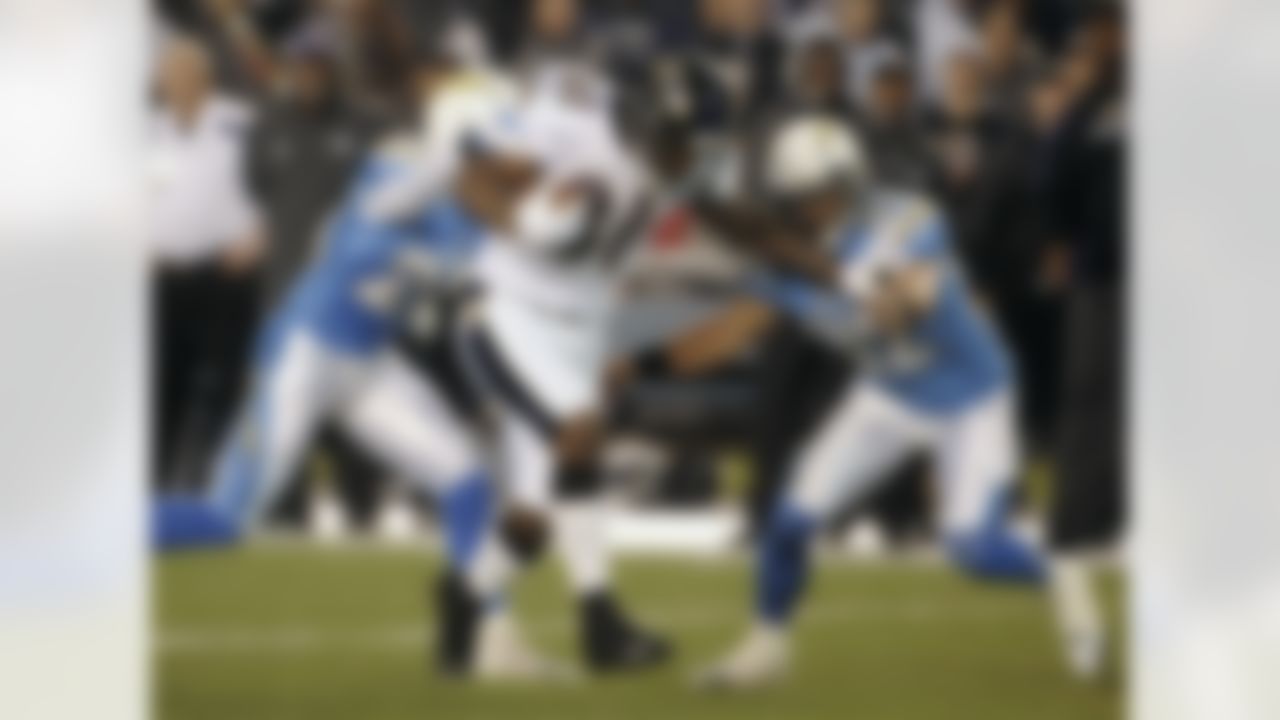 Baltimore Ravens wide receiver Anquan Boldin battles San Diego Chargers free safety Eric Weddle, right, and Antoine Cason while gaining 33 yards on a reception during the first half of a NFL football game Sunday, Dec. 18, 2011 in San Diego. (AP Photo/Denis Poroy)