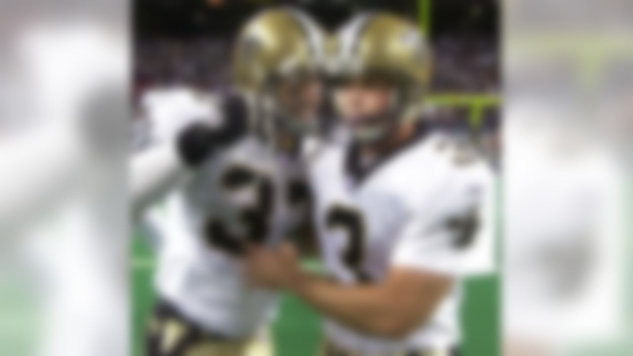 New Orleans Saints place kicker John Carney, right, is congratulated by safety Steve Gleason after Carney kicked the winning field goal in overtime against the St. Louis Rams in St. Louis, Sunday, Sept. 26, 2004. The Saints won, 28-25. (AP Photo/Charles Rex Arbogast)