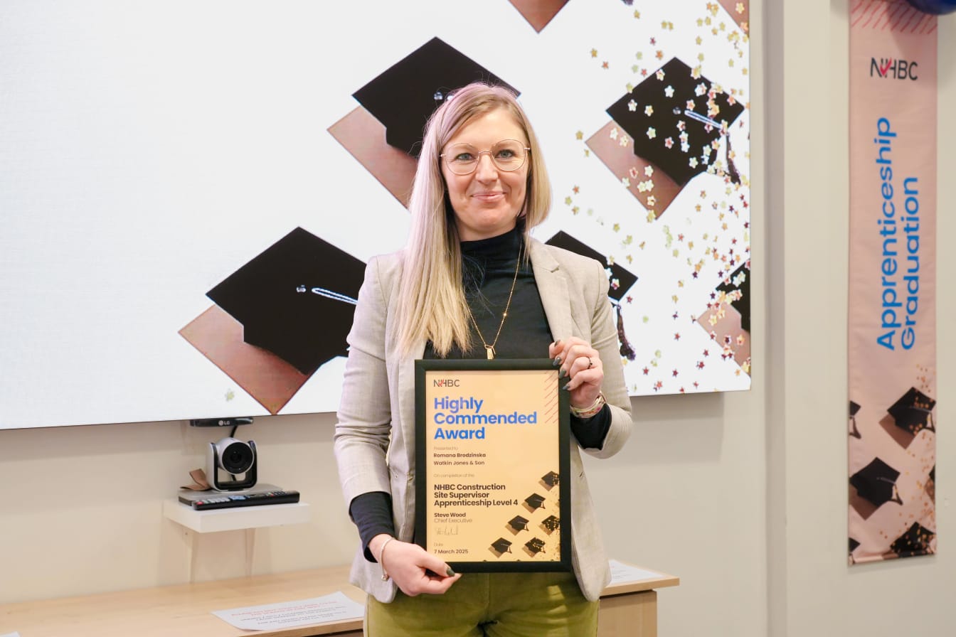 Romana Brodzinska smiling at the camera holding her certificate