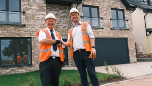 Eddie McCann from Robertson Homes shaking hands with his team