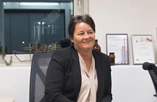 A photo of Karen Thornton smiling and looking off camera