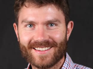 a photo of stefan szymoszowskyj smiling at the camera