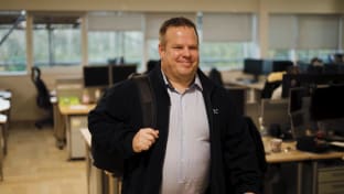 Neil Forton walking through the office