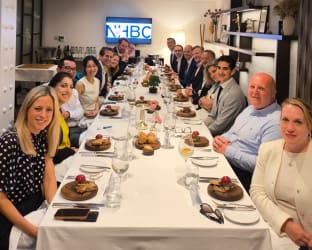 Roundtable image with a group of participants sat at a dining table