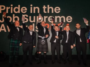 Pride in the Job Supreme Award 2024 winners celebrating and smiling at the camera