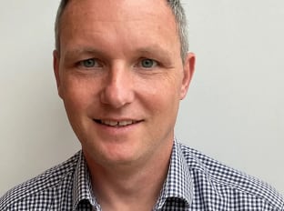 paul cribbens in a chequered shirt smiling at the camera