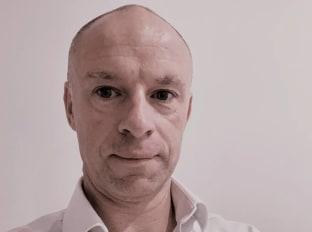 a photo of a man looking into the camera