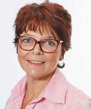 a photo of a woman wearing pink smiling at the camera