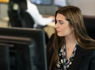 a young girl working on her computer in the nhbc office