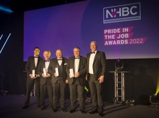 A photo of winners on stage at nhbc's pij awards