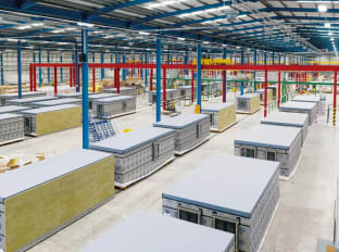 a warehouse full of prebuilt rooms covered in cladding
