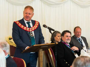 A photo of NHBC's Richard Smith on stage delivering a speech