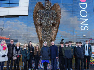 a photo of some nhbc team members in front of the knife angel structure