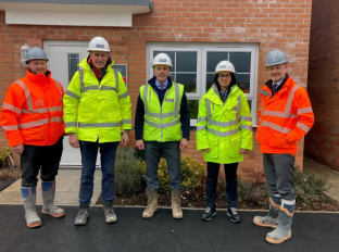 The shadow minister for business and industry on site with staff in high vis jackets
