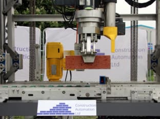 an innovative bricklaying machine being demonstrated