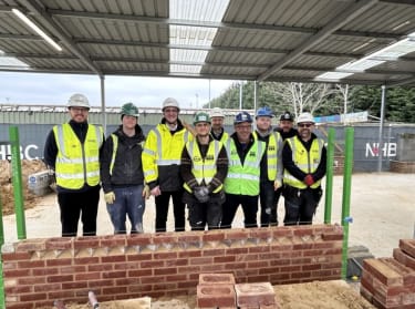 apprentices at nhbc's cambridge training hub smiling at the camera