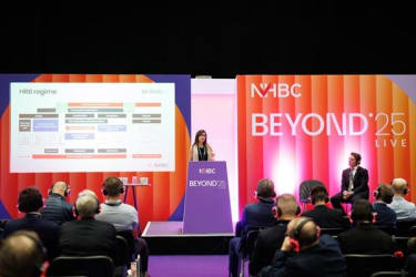 A speaker on stage at BEYOND '25 LIVE