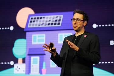 A speaker on stage at BEYOND '25 LIVE on a purple background