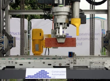 an innovative bricklaying machine being demonstrated