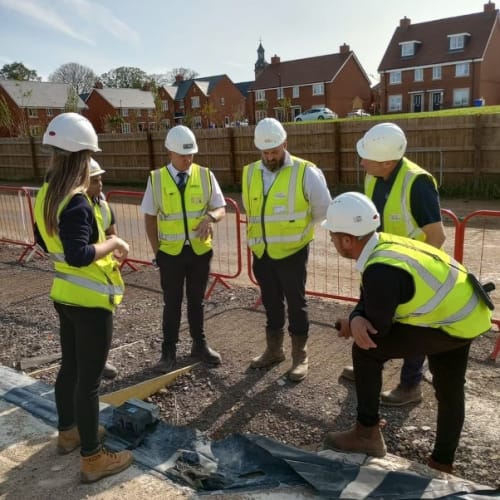 Nhbc workers standing in group on new construction site
