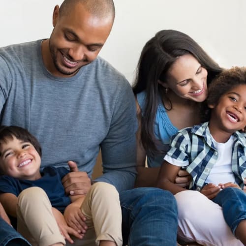 Family of four smiling