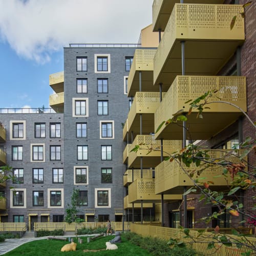 A Homeowners warranty building with balconies and grass