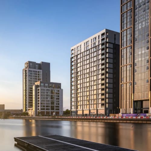 City scape with high rise buildings next to water in sunshine