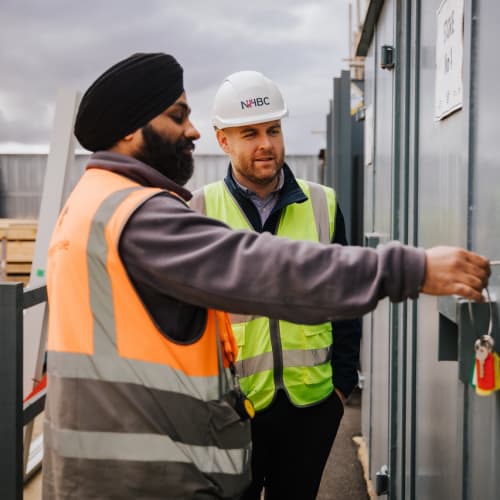 NHBC team on site with safety jacket and hard hat