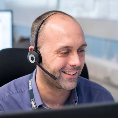 NHBC staff in the office with headset on