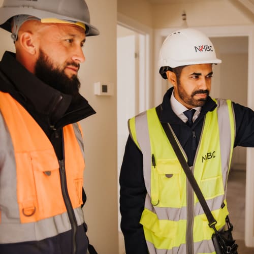 NHBC inspection team looking at a wall