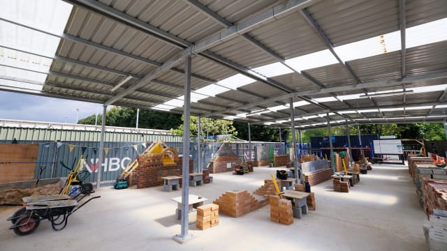 the concrete slab are the Cambridge Training Hub showing realistic site conditions.