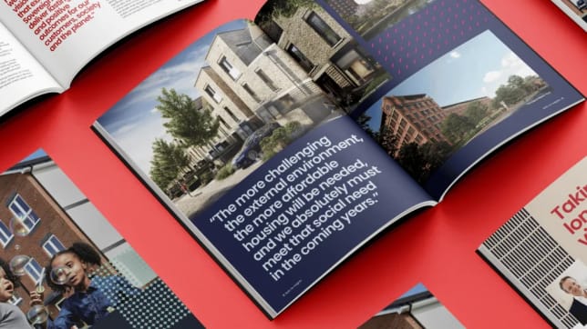 a photo of a housing association booklet on a red background