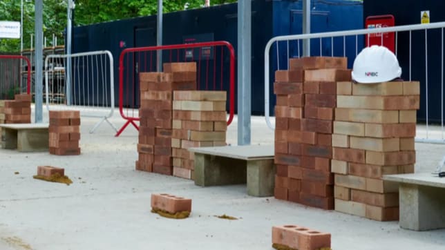 Bricks stacked with NHBC hard hat