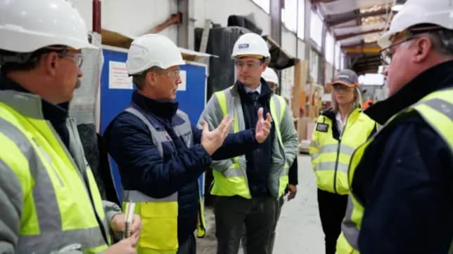 NHBC teams with safety jackets and hard hats in building