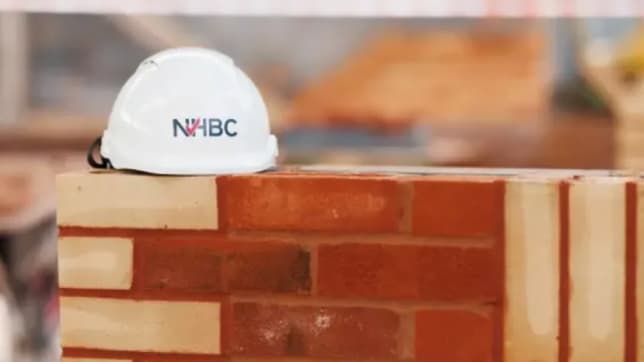 NHBC hard hat on brick wall