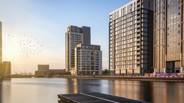 City scape with high rise buildings next to water in sunshine