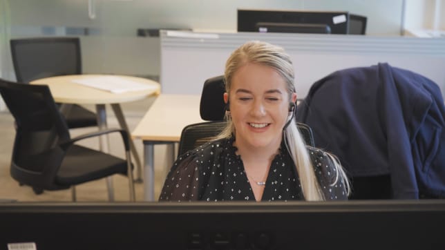 Shannon Thornthwaite at her desk on a call
